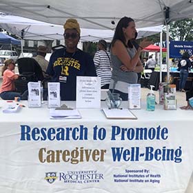 Two women in booth display for caregiver well-being